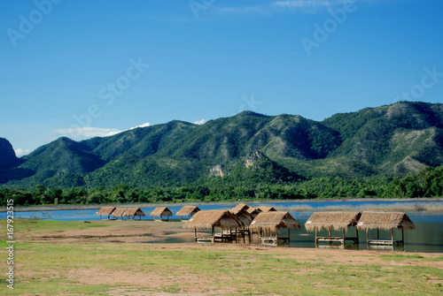 Small huts at lake shore surrounded by mountains