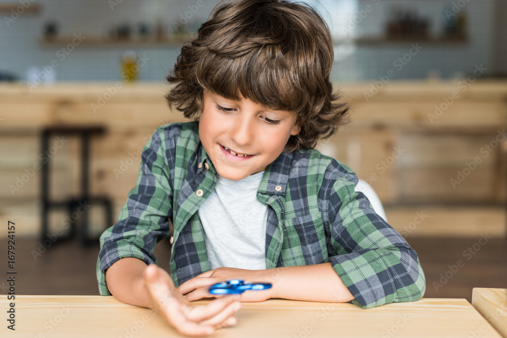 cute smiling boy with fidget spinner in hand cute smiling boy with fidget spinner in hand