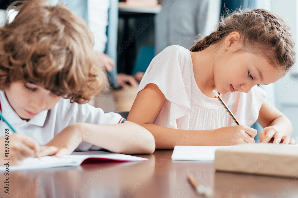 pensive little kids doing homework together pensive little kids doing homework together