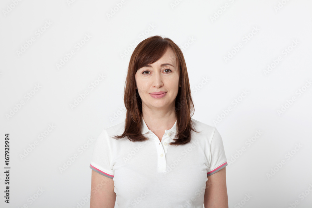 Portrait of smiling beautiful brunette woman in blank white t-shirt with copy space on white. Mothers day background. Mock up Portrait of smiling beautiful brunette woman in blank white t-shirt with copy space on white. Mothers day background. Mock up