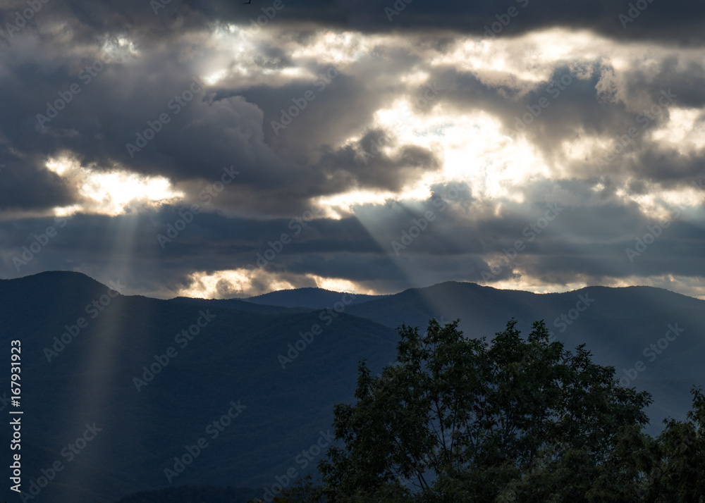 Crepuscular rays appearing through gaps in the clouds at day end