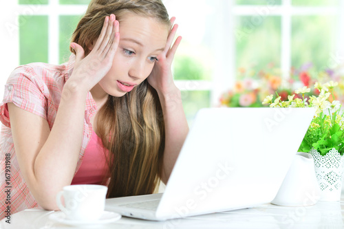 Teen girl using laptop
