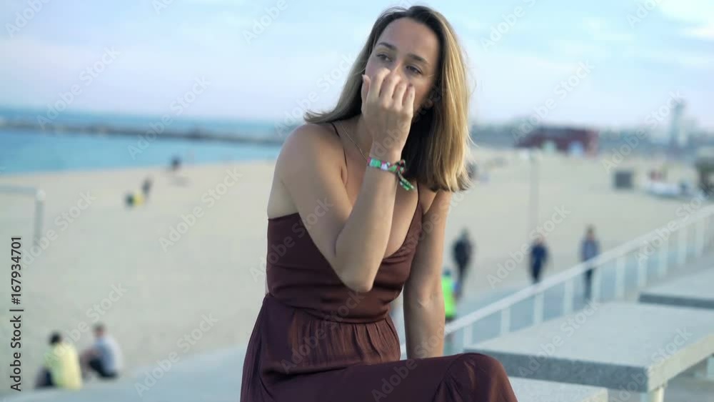 Sad, pensive woman sitting near beach in city
Sad, pensive woman sitting near beach in city