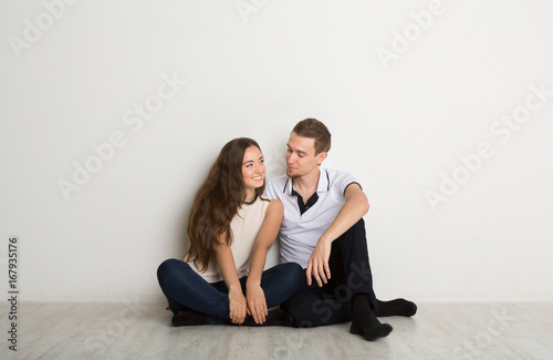 Happy couple looking at each other on floor