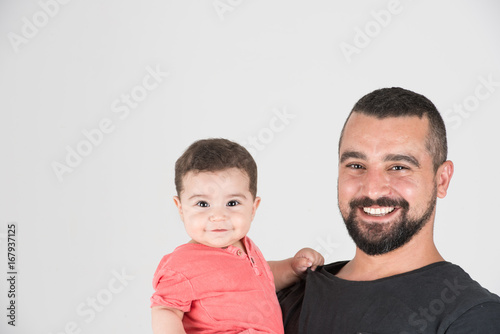 Fotografie Headshot of father and son smiling together