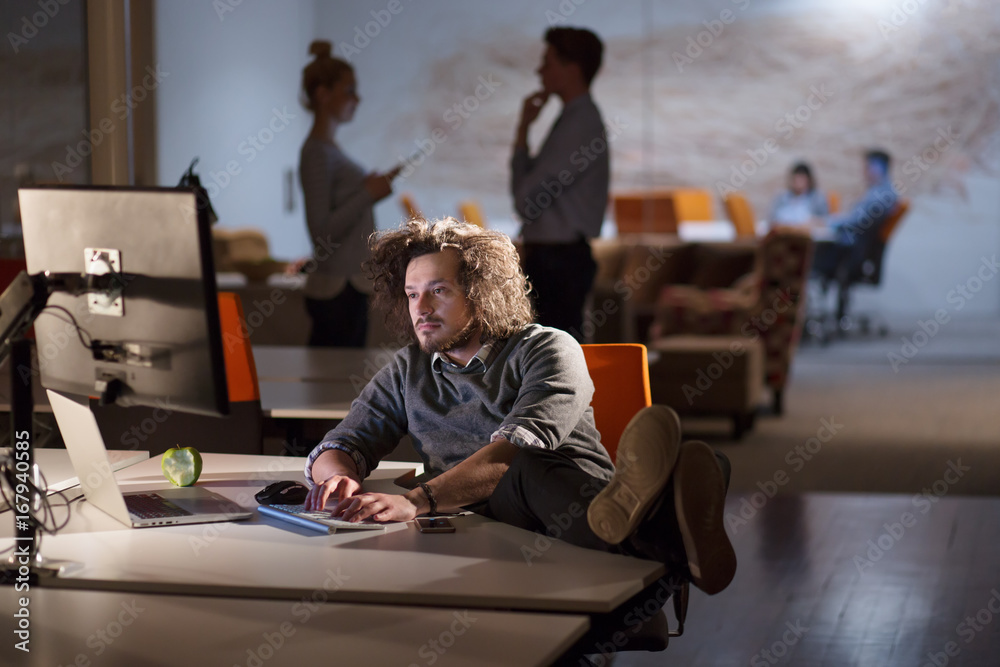 businessman sitting with legs on desk at office businessman sitting with legs on desk at office
