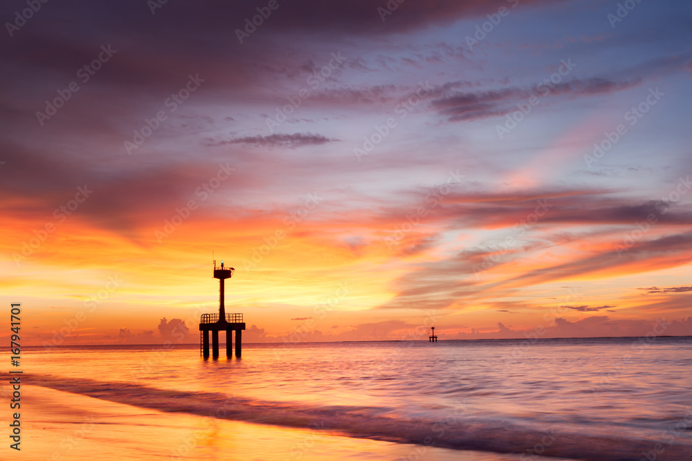 Twilight after sunset on the beach with lighthouse