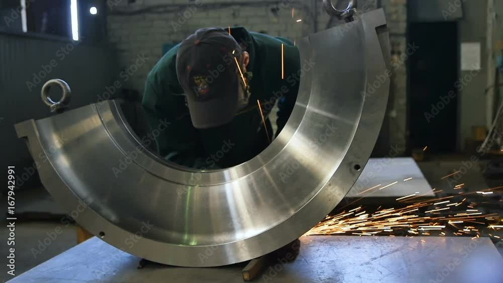 Skilled Worker in Protective Mask Works in Spark Shower Skilled Worker in Protective Mask Works in Spark Shower