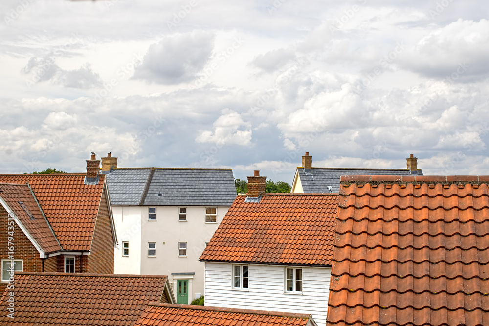Real estate. Suburban property roof tops on a modern contemporary housing estate. Real estate. Suburban property roof tops on a modern contemporary housing estate.
