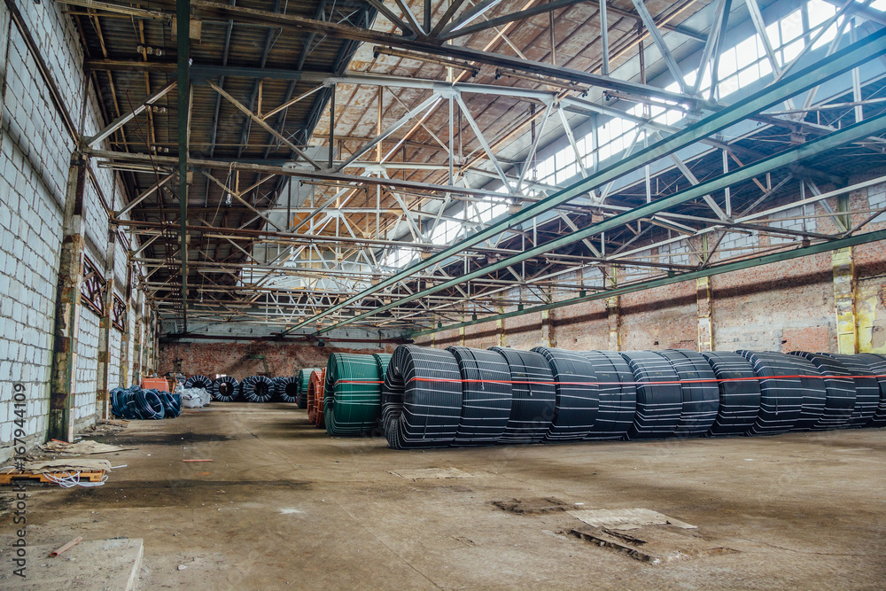 Warehouse with production twisted rubber tubing of industrial hoses Warehouse with production twisted rubber tubing of industrial hoses