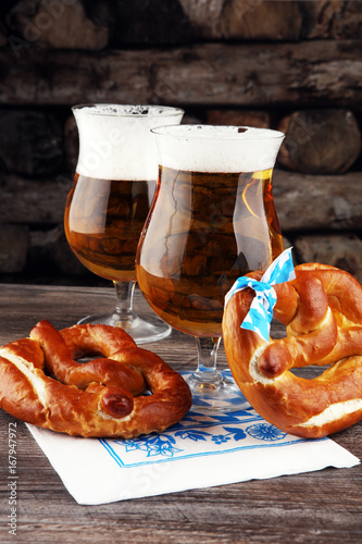 Original bavarian pretzels with beer on wooden board. Oktoberfes photo