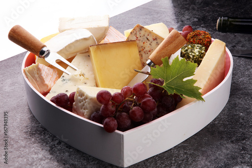 Photography Cheese platter with different cheese and grapes