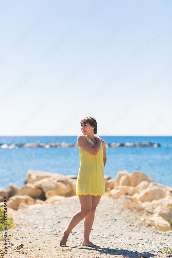 Beautiful girl relaxing and smiling outdoor at summer beach Beautiful girl relaxing and smiling outdoor at summer beach