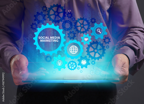 Business, Technology, Internet and network concept. Young businessman working on a virtual screen of the future and sees the inscription: Social media marketing