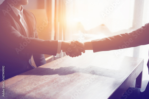 Great job,Sealing deal,Successful business,Handshake,Businessman join together,Good agreement.two business people shaking hands standing at the working place,business partners,selective focus,Vintage