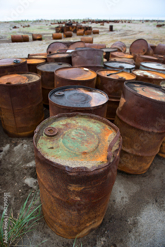 Rusted barrels on the shore, Chukotka, Russia
