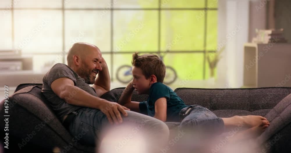 Fother and son kidding around on the couch Fother and son kidding around on the couch