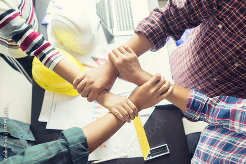 Stack hands of business engineering teamwork join together,construction engineer working in construction site, construction engineer conceptual,architect drawing on architectural project on background