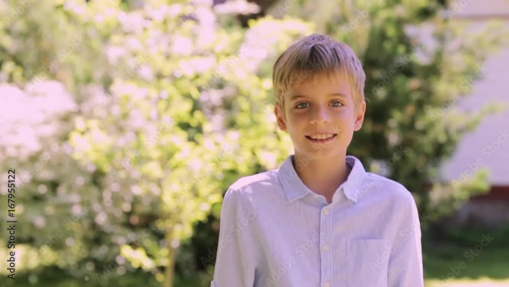 smiling preteen boy outdoors at summer garden smiling preteen boy outdoors at summer garden