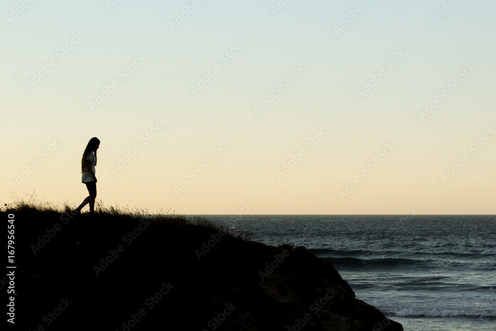 Girl walking on coastline Girl walking on coastline