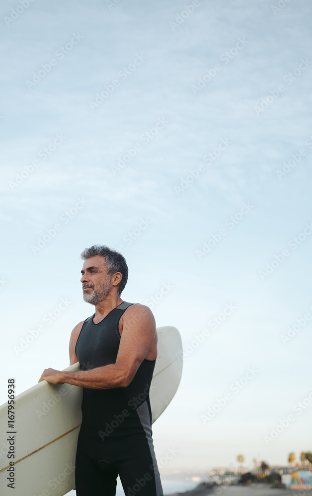 Mature surfer man on the beach