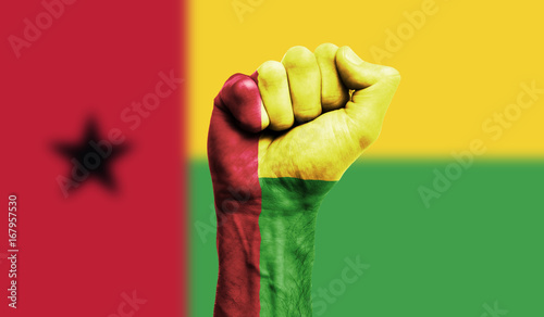 Photos Guinea Bissau flag painted on a clenched fist