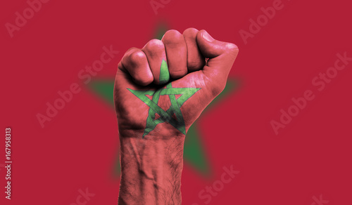 Morocco flag painted on a clenched fist. Strength, Power, Protest concept