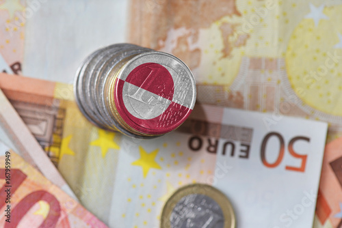 euro coin with national flag of greenland on the euro money banknotes background.