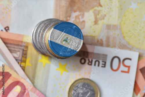 euro coin with national flag of nicaragua on the euro money banknotes background.
