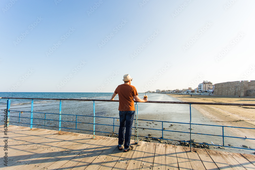handsome bearded man with paper cup of morning coffee walking in morning. handsome bearded man with paper cup of morning coffee walking in morning.