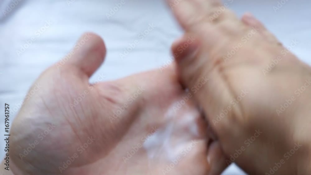 apply skin care cream from the tube on a hand palms rubbing each other. closeup point of view shot apply skin care cream from the tube on a hand palms rubbing each other. closeup point of view shot