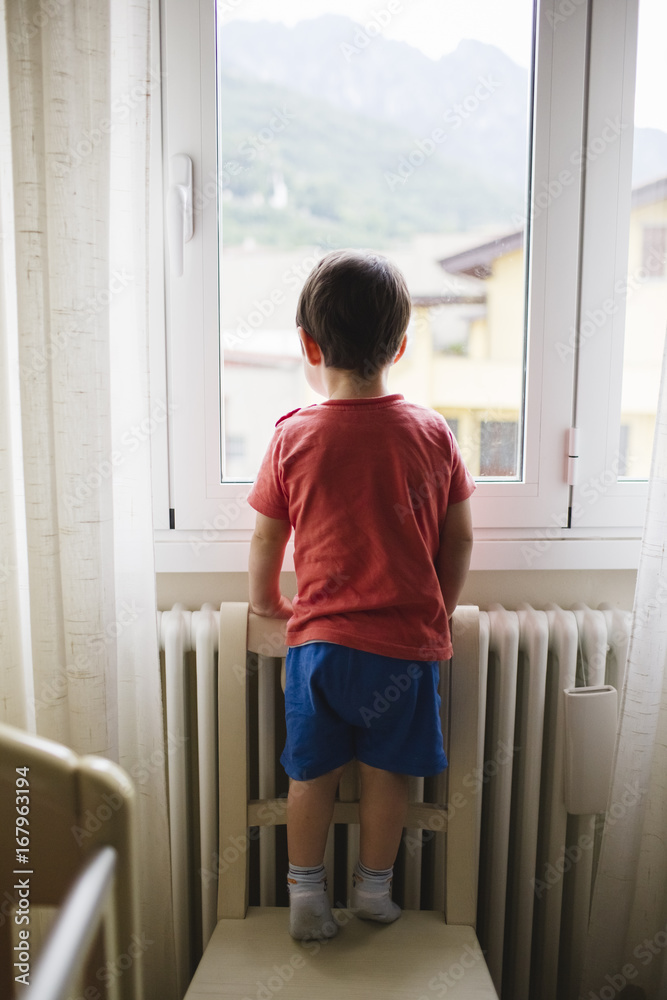 Child looking out the window Child looking out the window
