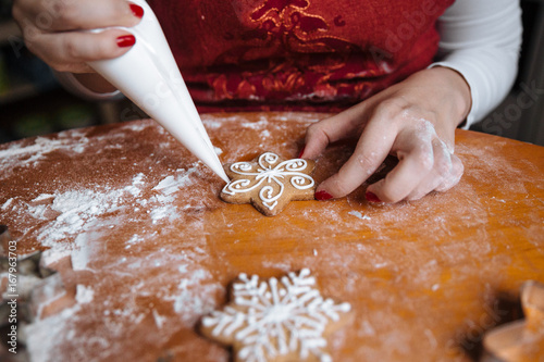 Woman decorating Christmas cookies photo
