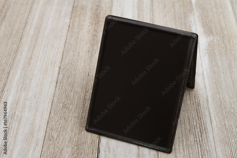 Retro freestanding chalkboard on weathered wood Retro freestanding chalkboard on weathered wood