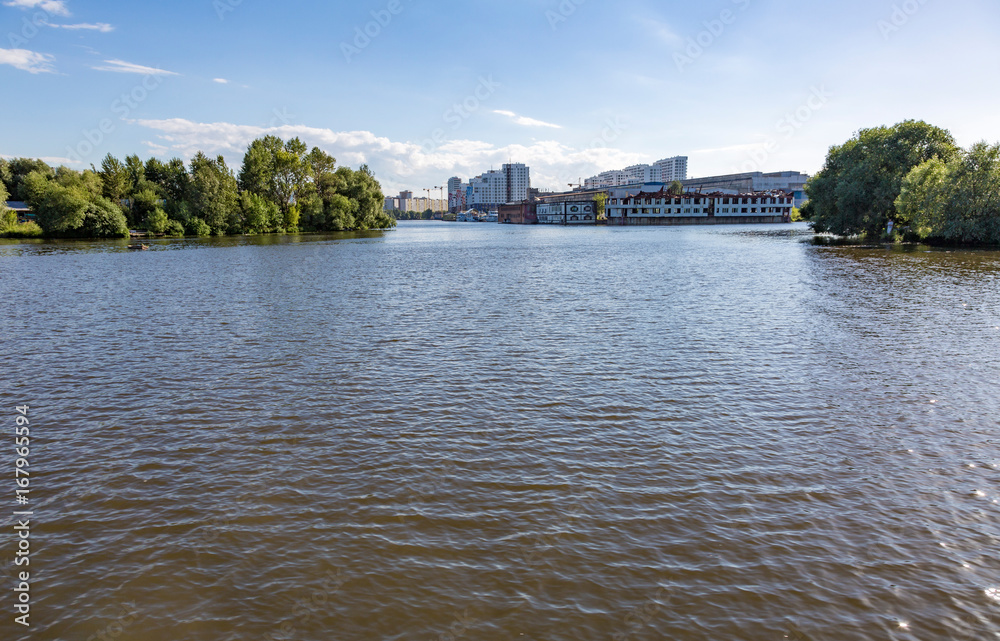 Wide river in the city on a summer day
