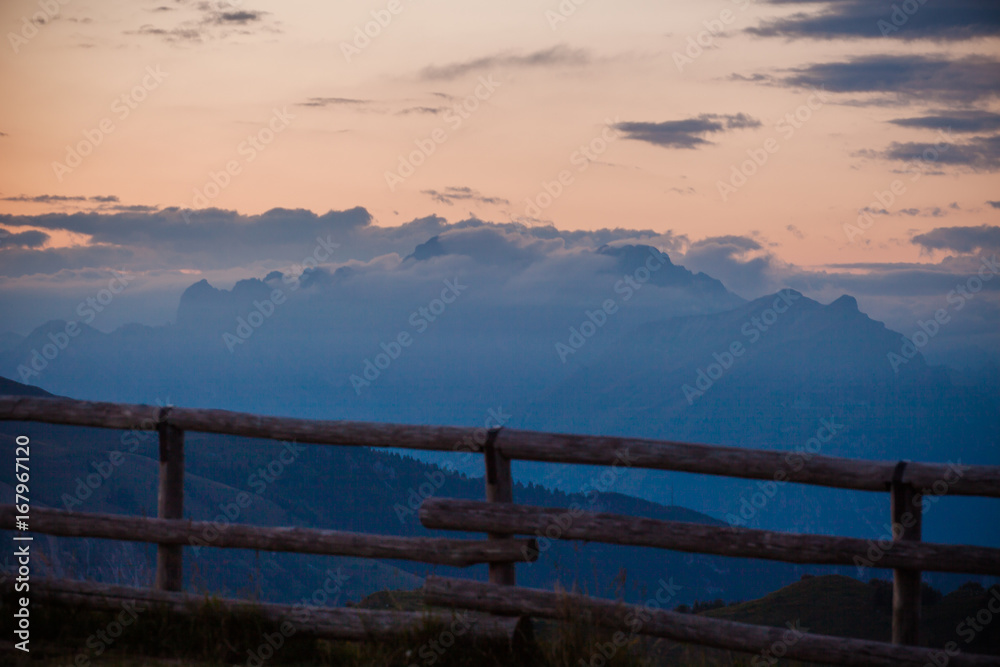Sunset on Dolomites silhouette with clouds from Monte Pizzoc summit, Veneto, Italy Sunset on Dolomites silhouette with clouds from Monte Pizzoc summit, Veneto, Italy