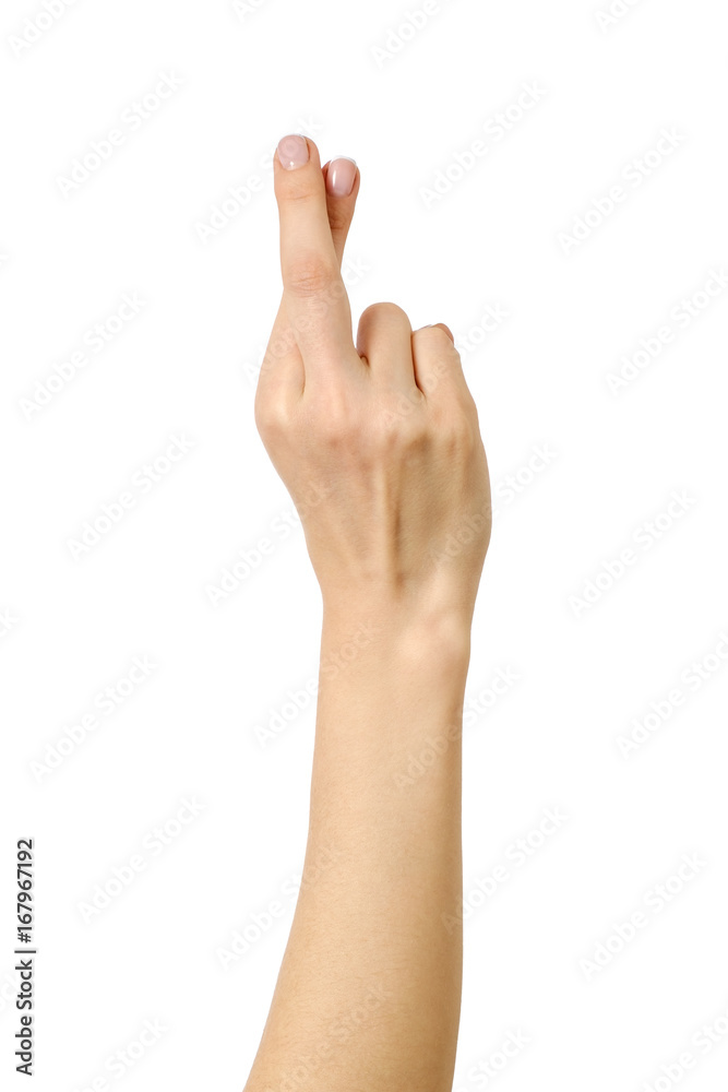 Woman's hand showing crossed fingers lie symbol Woman's hand showing crossed fingers lie symbol