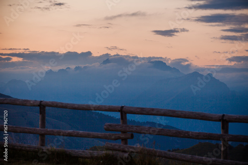 Sunset on Dolomites silhouette with clouds from Monte Pizzoc summit  Veneto  Italy