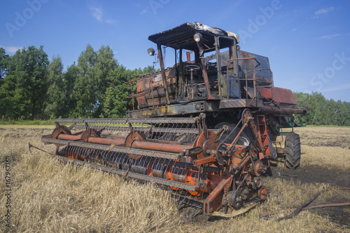 Old combine harvester lighted up on harvesting of the grain