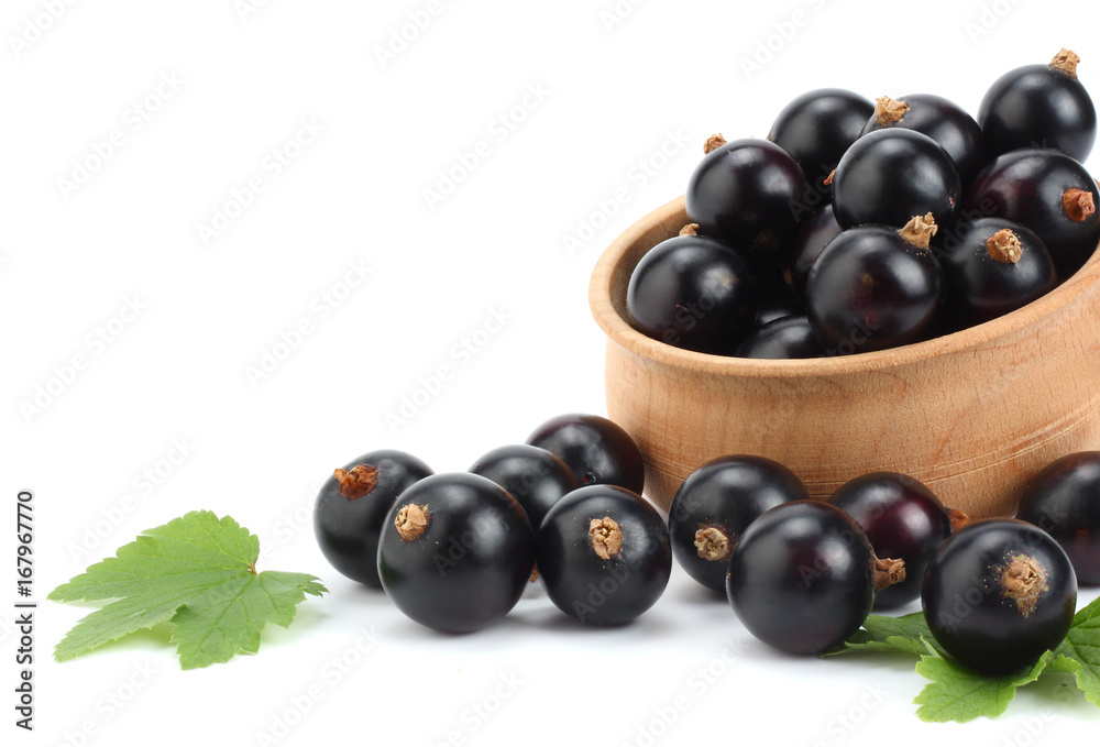 black currant in wooden bowl with green leaf isolated on white background black currant in wooden bowl with green leaf isolated on white background
