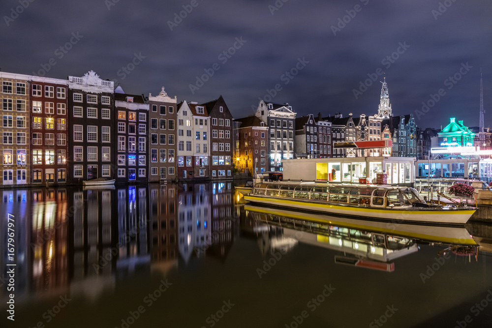 Colored homes on the water in Amsterdam at night