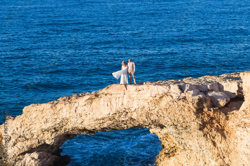 beautiful gorgeous bride and stylish groom on rocks.