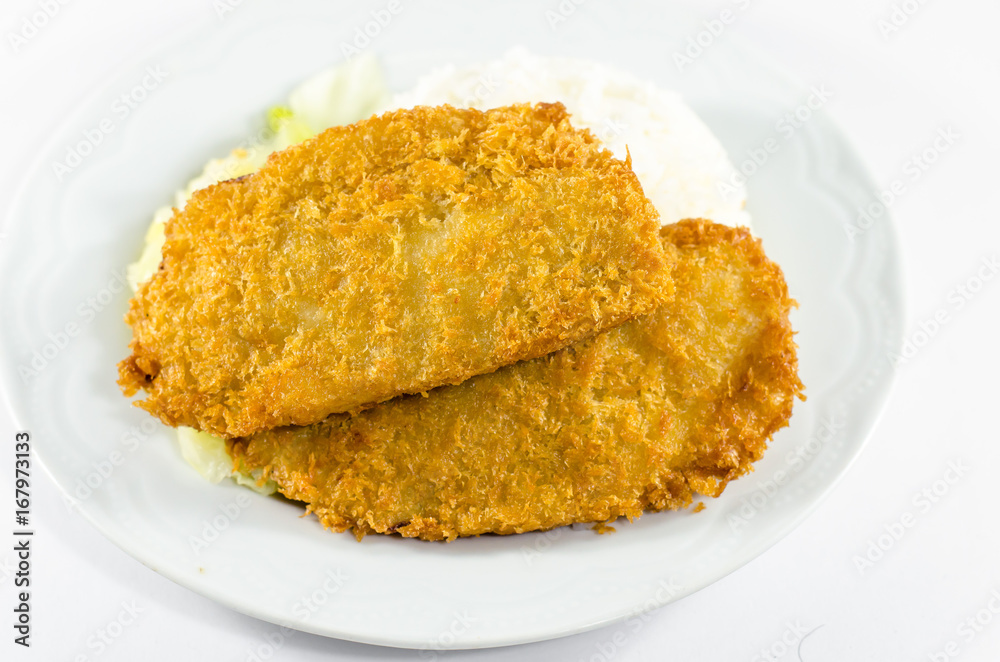 Fried fish with vegetable on white plate