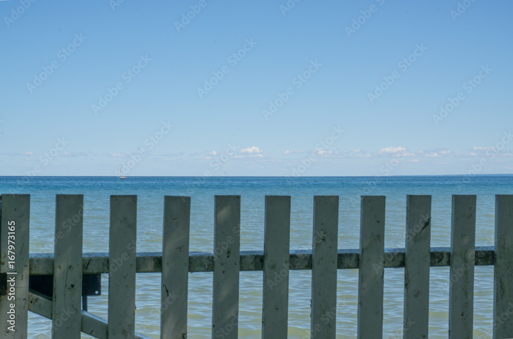 View of Sailboat over fence 