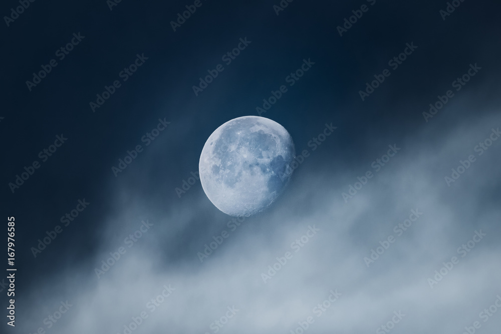 Moon with light clouds in its waning gibbous phase during morning Moon with light clouds in its waning gibbous phase during morning
