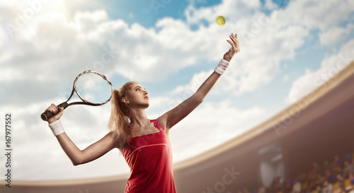 Tennis serve by female tennis player on court © TandemBranding