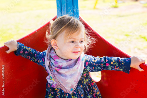 Portrait of beautiful young baby girl on the playground photo