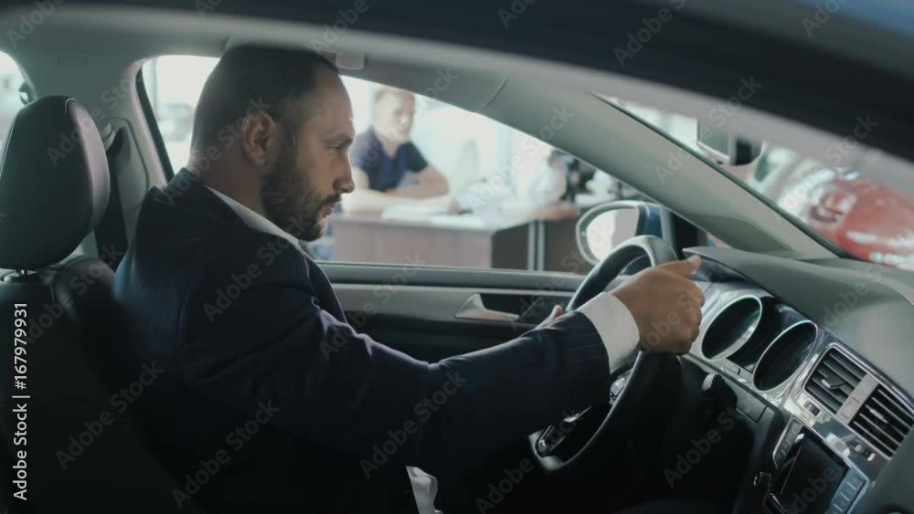 The customer gives a credit card to a salesman in car dealership The customer gives a credit card to a salesman in car dealership