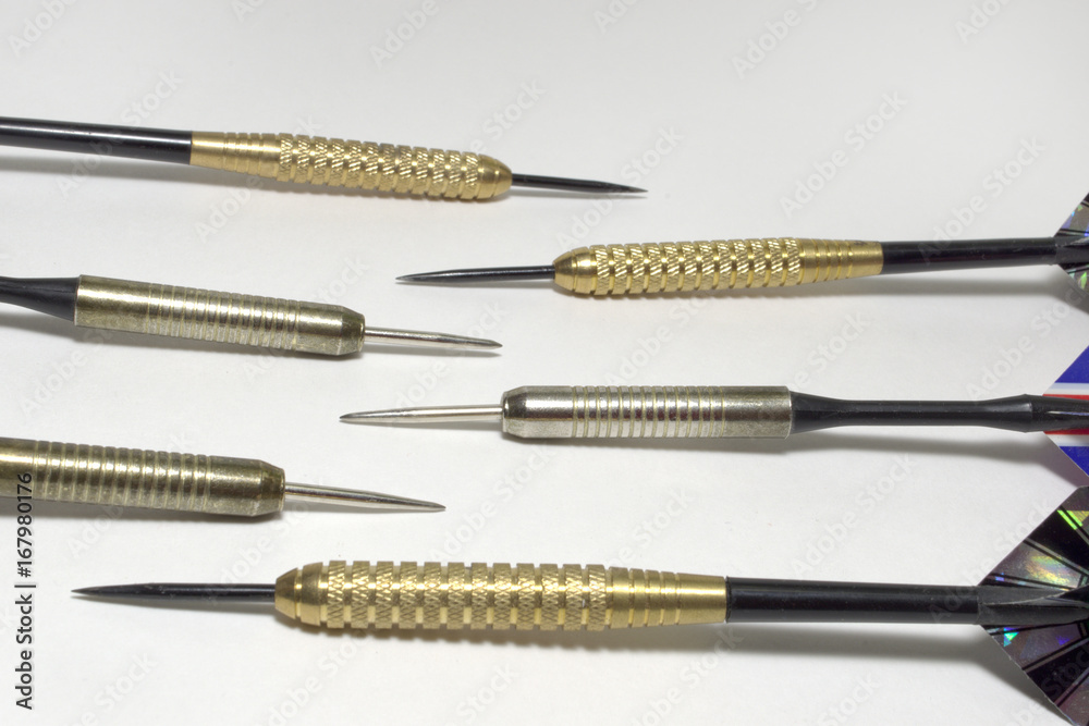 Six darts needles closeup. Sharp Steel. Brass and stainless steel barrels Six darts needles closeup. Sharp Steel. Brass and stainless steel barrels