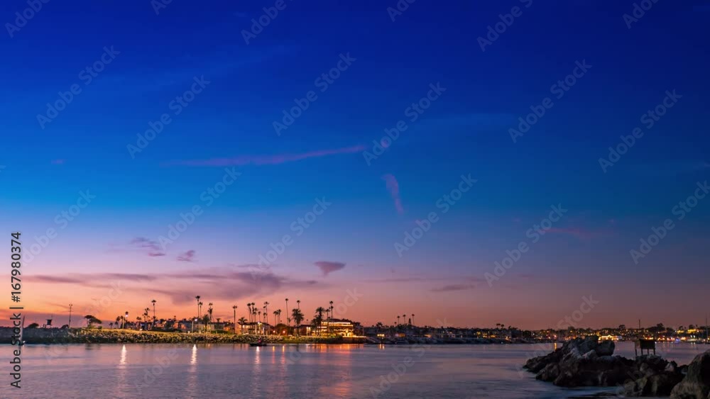 Cinematic 4K timelapse over the Newport Beach harbor at sunset with boats, yachts and ferries passing by at twilight with the sky turning from blue to pink. Cinematic 4K timelapse over the Newport Beach harbor at sunset with boats, yachts and ferries passing by at twilight with the sky turning from blue to pink.